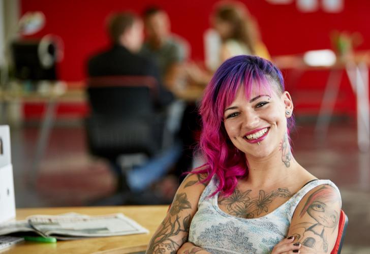 Young Woman with smiling with her arms folded.